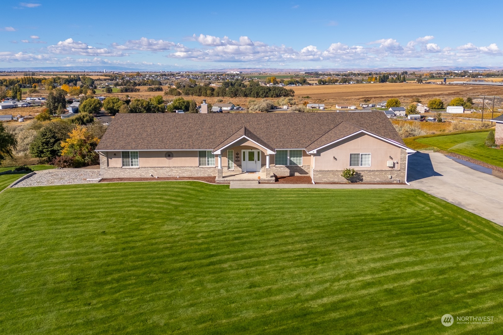 a aerial view of a house with a garden and lake view