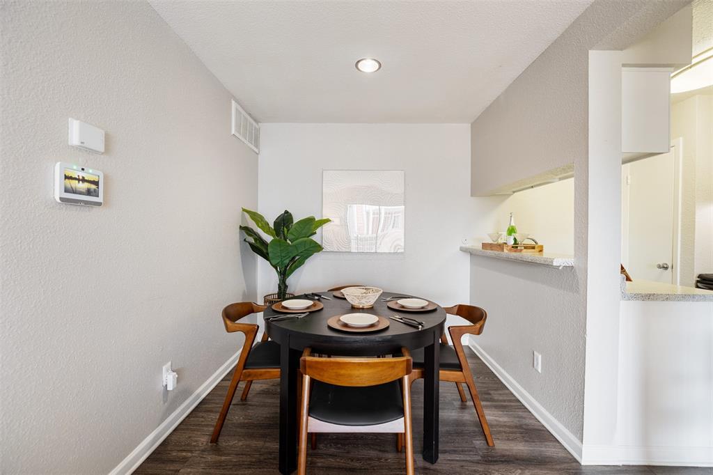 a dining room with furniture and wooden floor