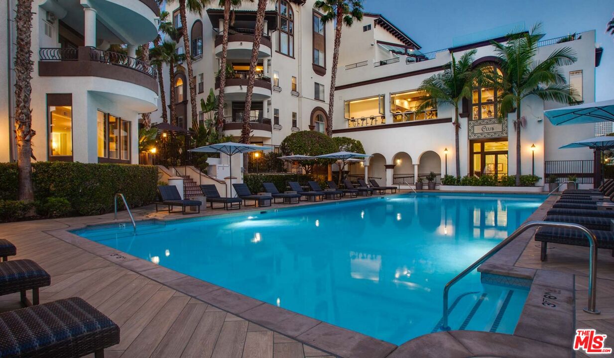 a view of a swimming pool with outdoor seating