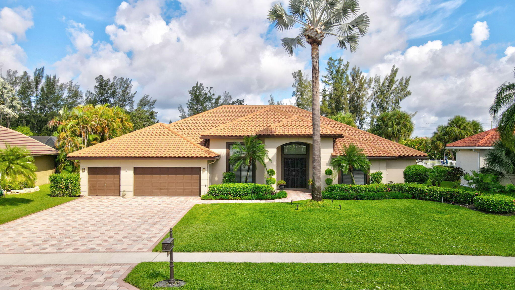 a front view of a house with a garden