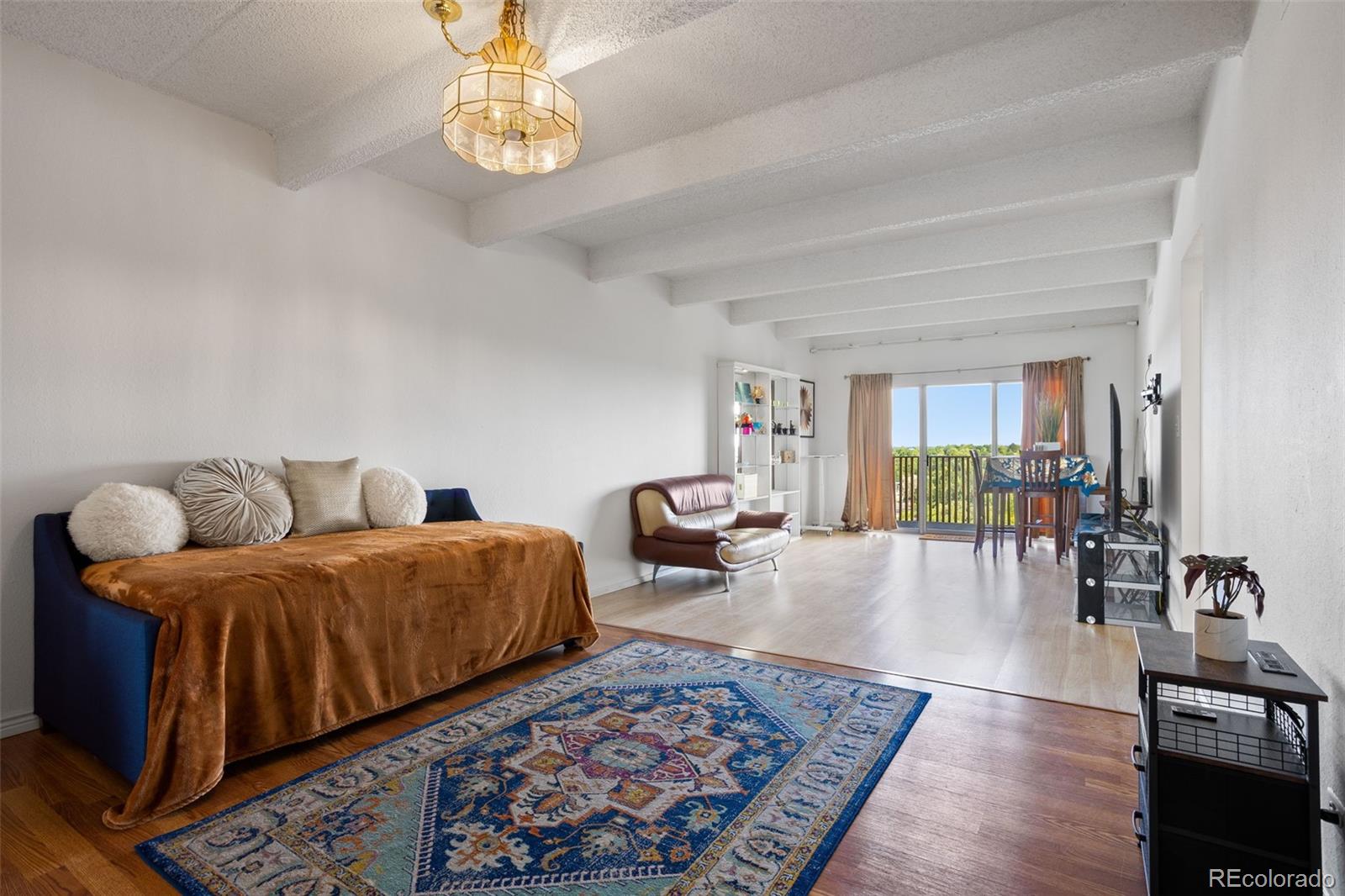 a living room with furniture and a chandelier