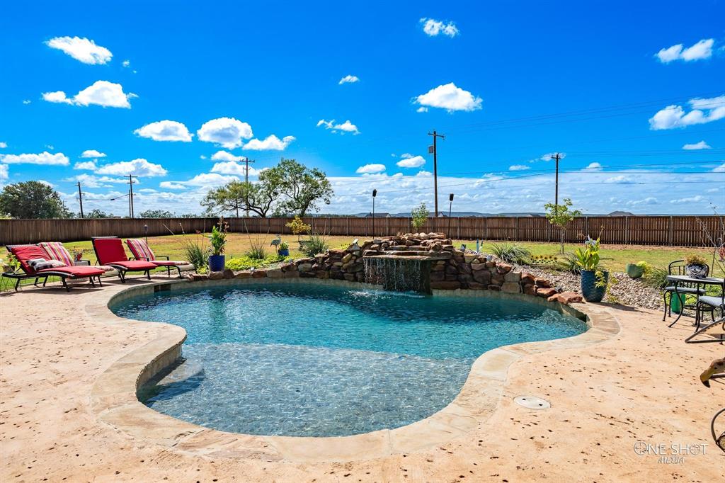 a view of a swimming pool with a chairs