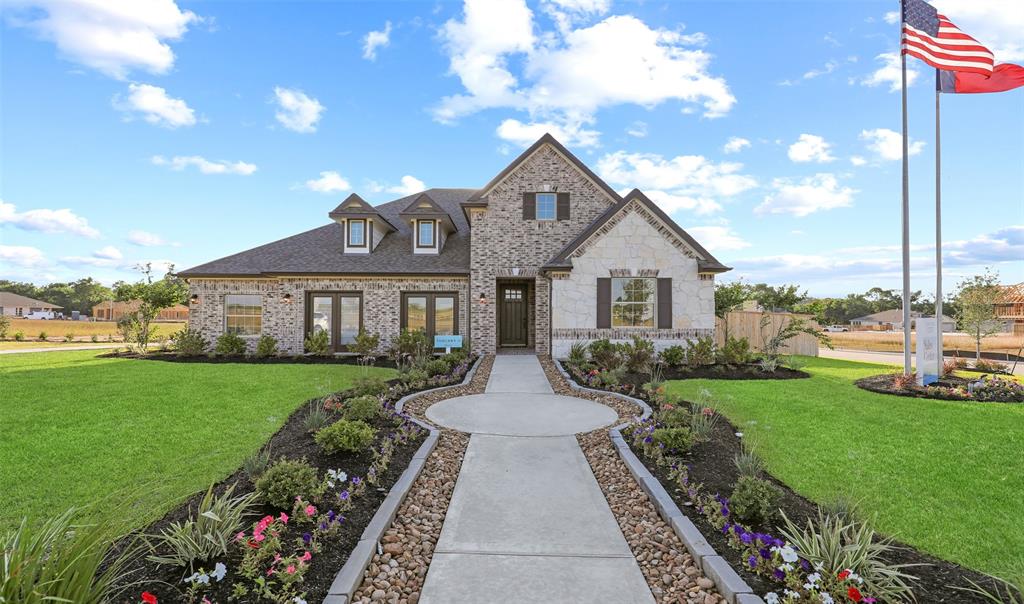 a front view of house with yard and green space