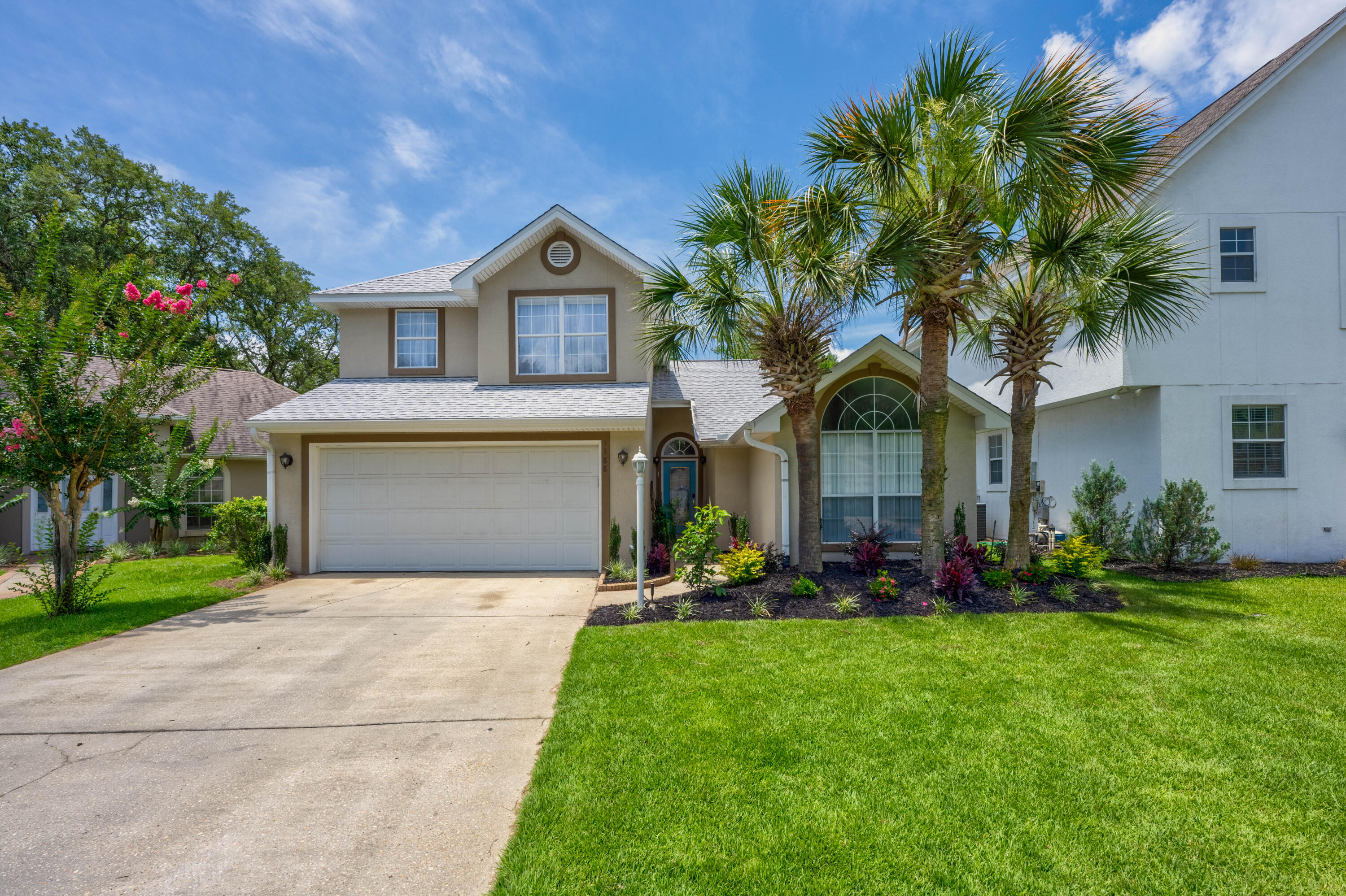 a front view of house with yard and green space