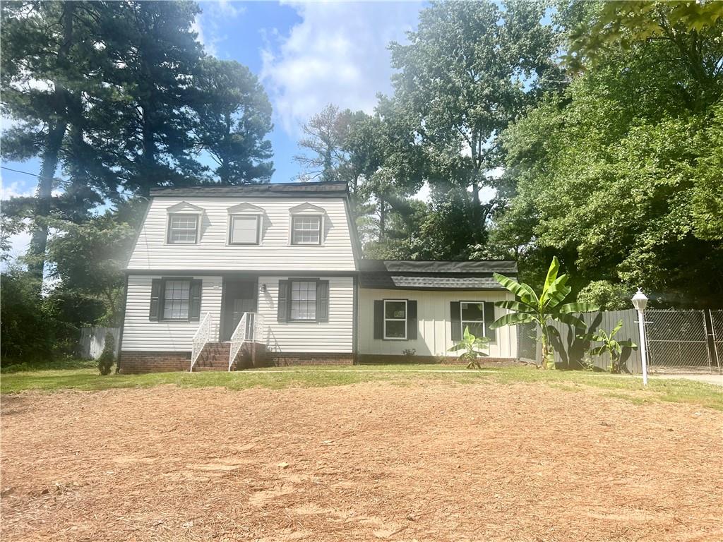 a front view of a house with a garden