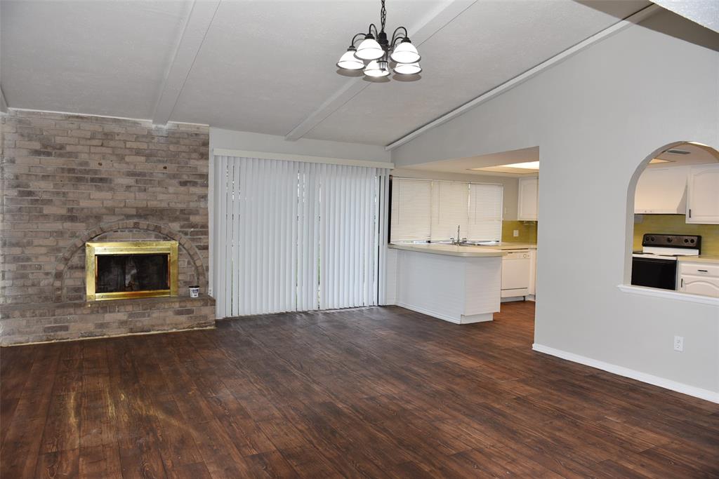 open value ceiling in family room with fireplace