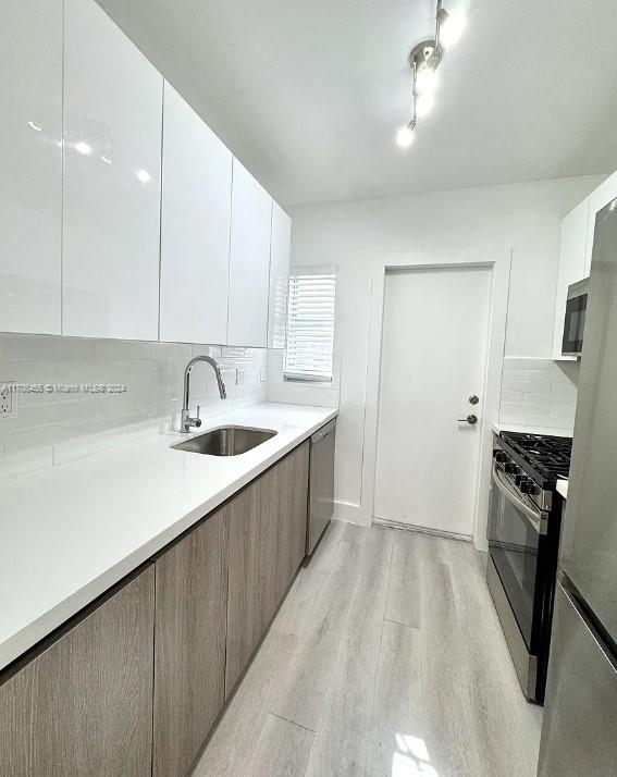 a kitchen with a sink appliances and cabinets