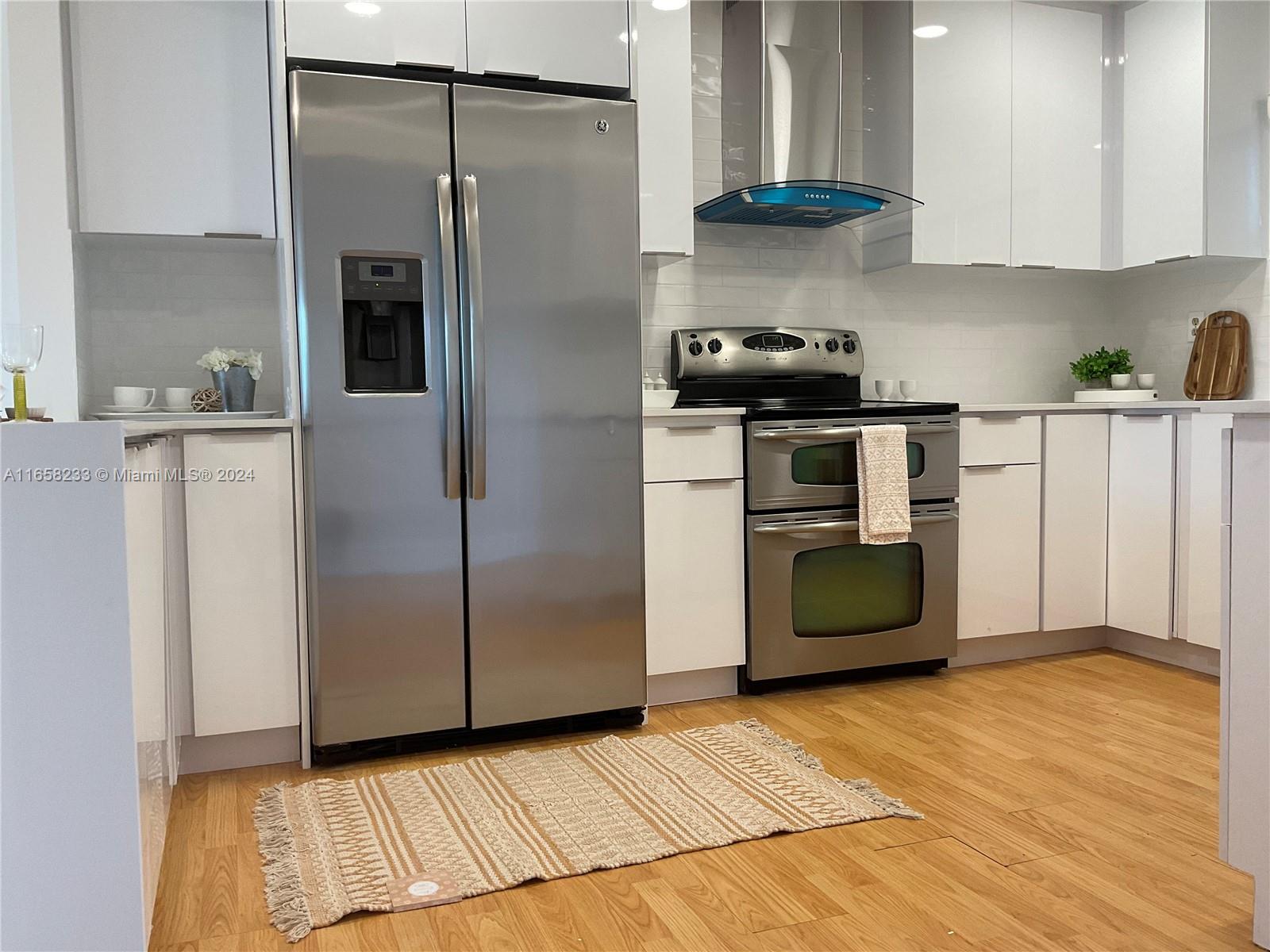 a kitchen with a refrigerator a stove and a cabinets