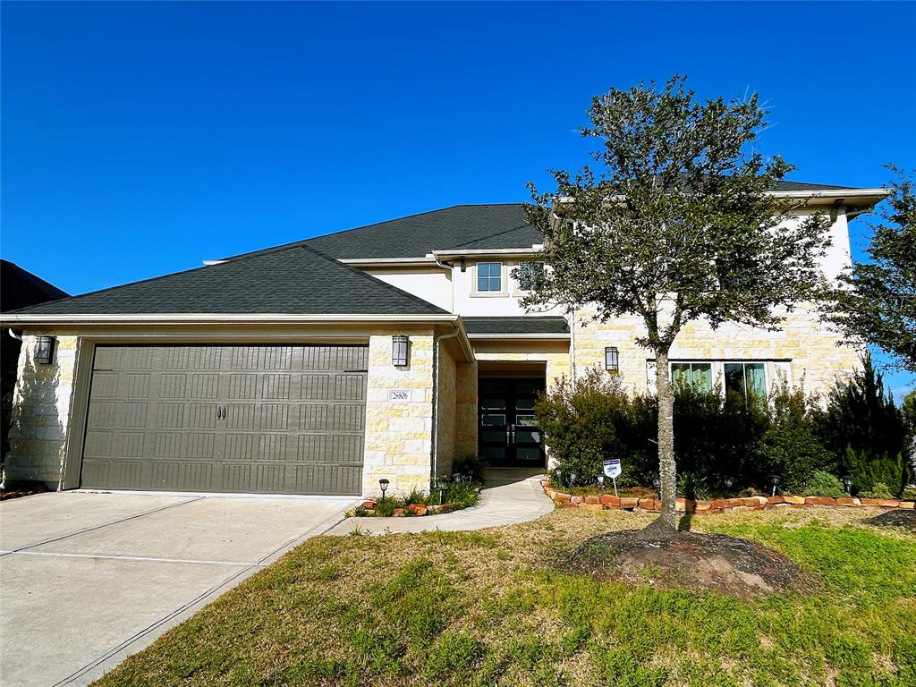 a front view of a house with a yard and garage