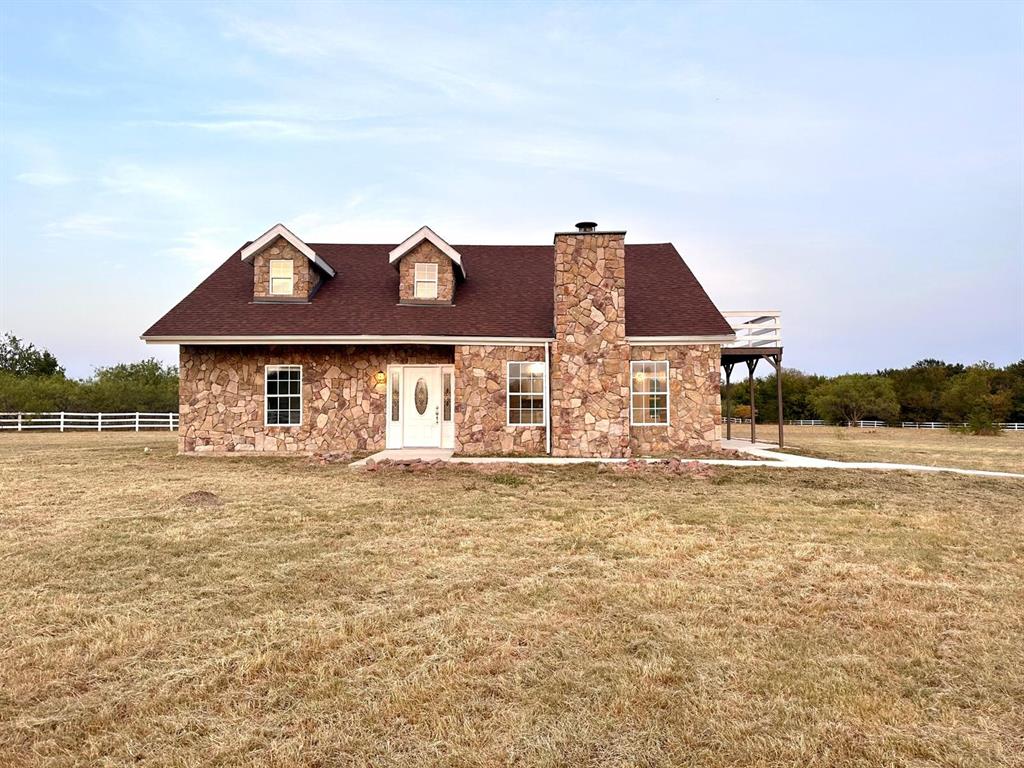 a front view of house with yard and seating