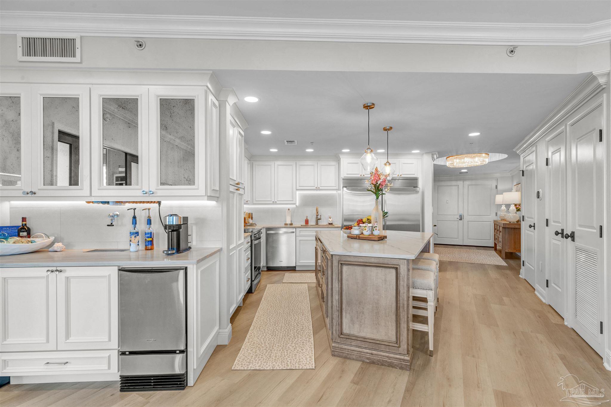 a kitchen with stainless steel appliances kitchen island granite countertop a sink and cabinets