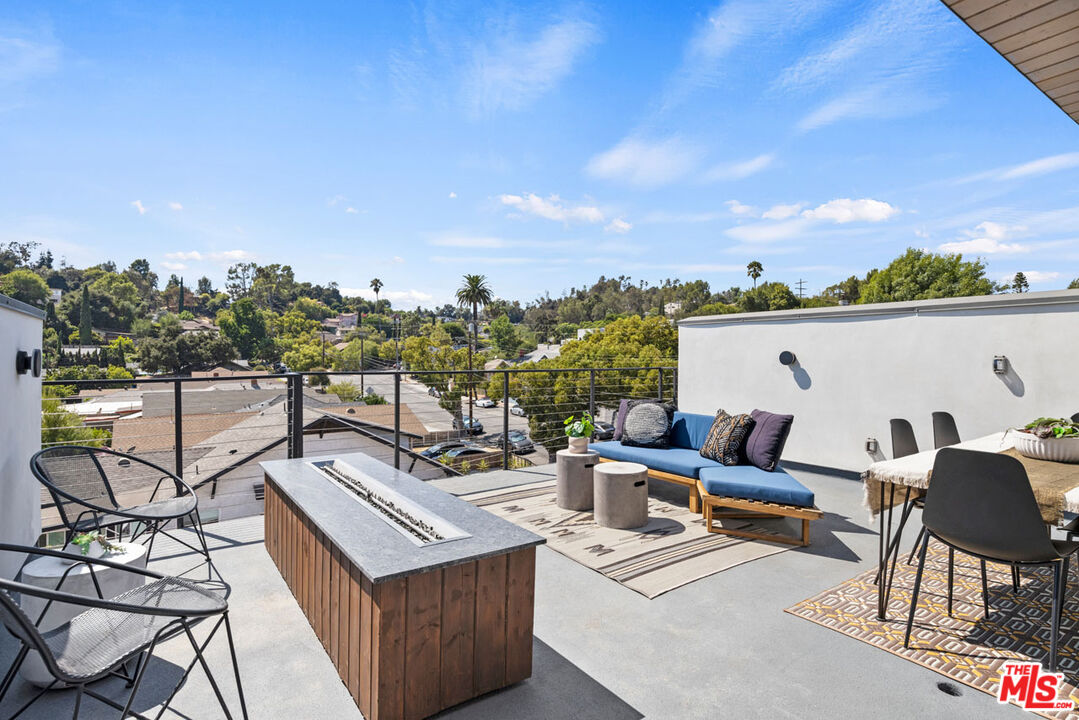 a view of a terrace with couches and lounge chairs