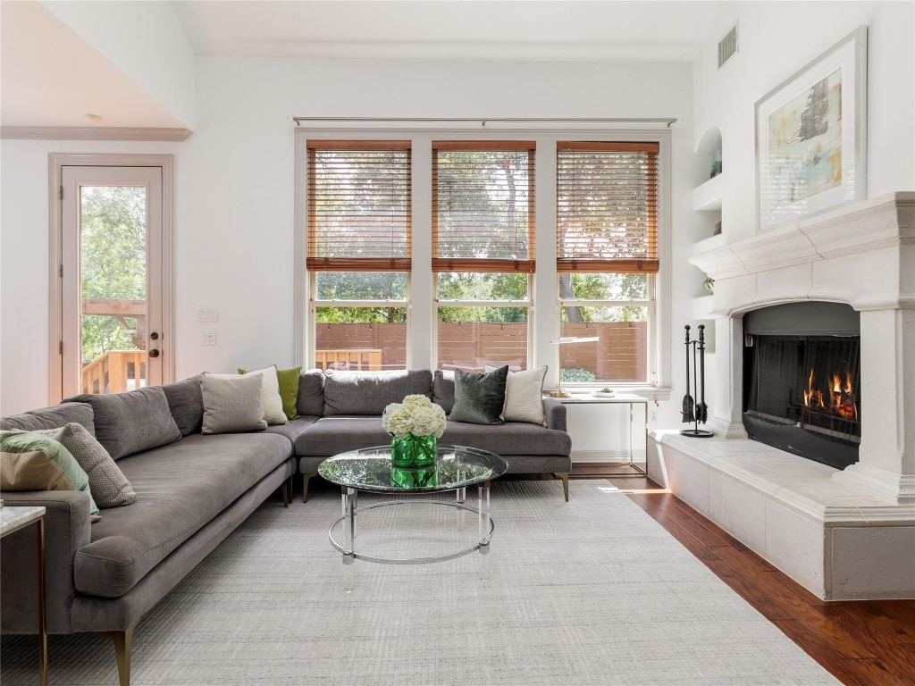 a living room with furniture and a fireplace