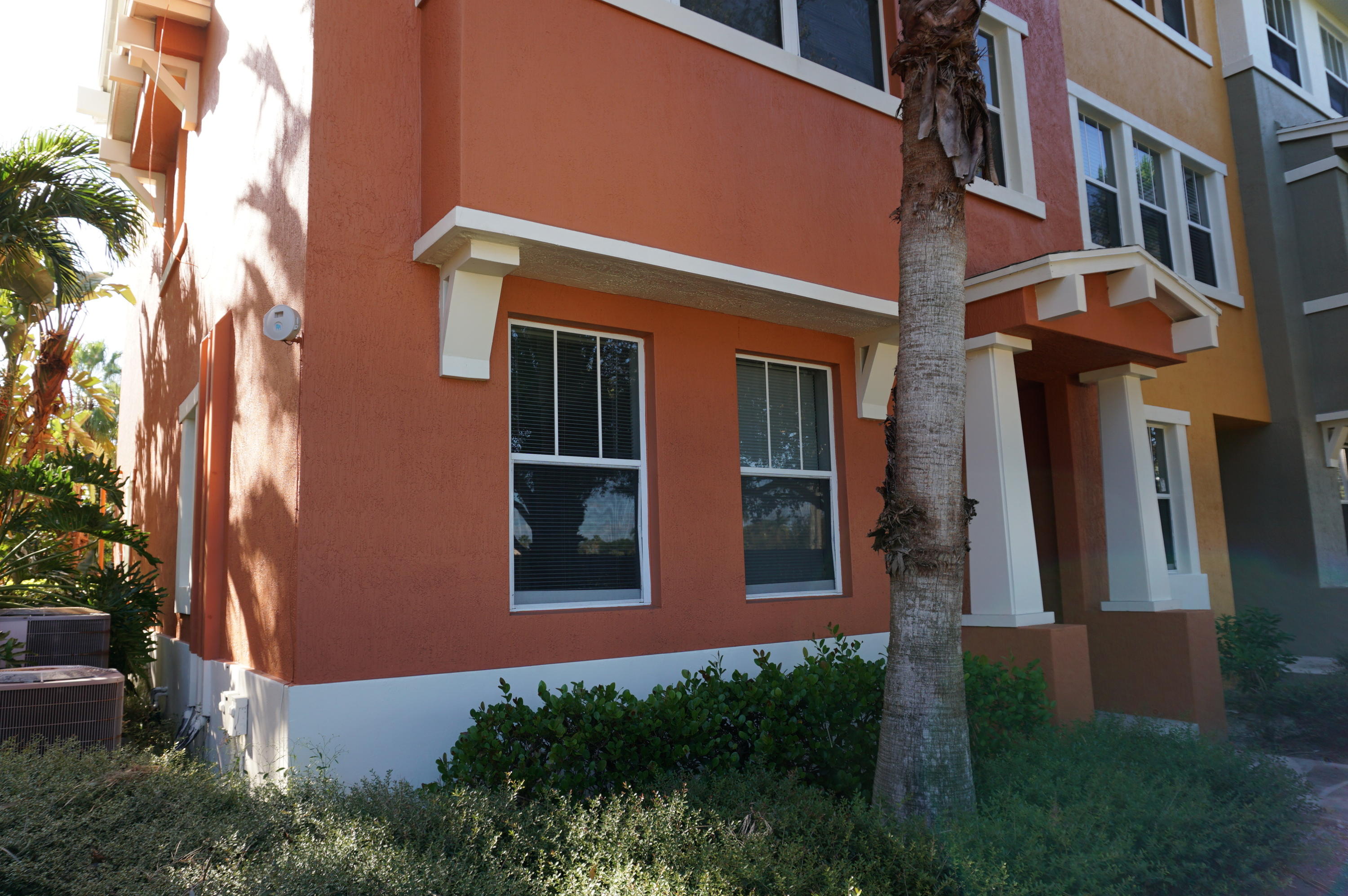 a view of a building with many windows and a yard