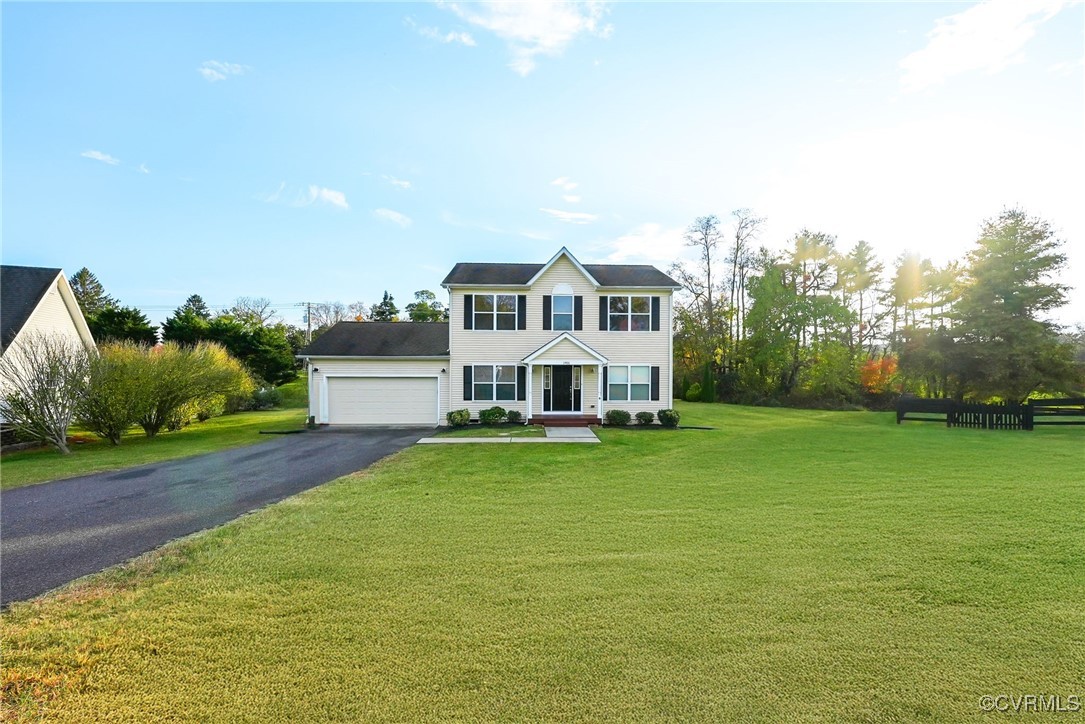 Colonial-style house with covered porch, a front y