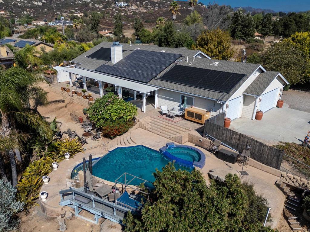 an aerial view of a house with yard swimming pool and outdoor seating