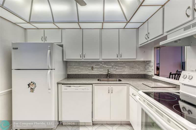 Newer cabinets and corian counters.