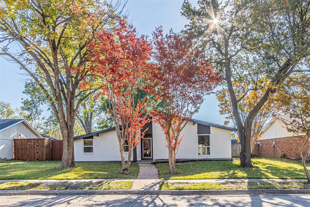 a view of a house with a yard and tree s