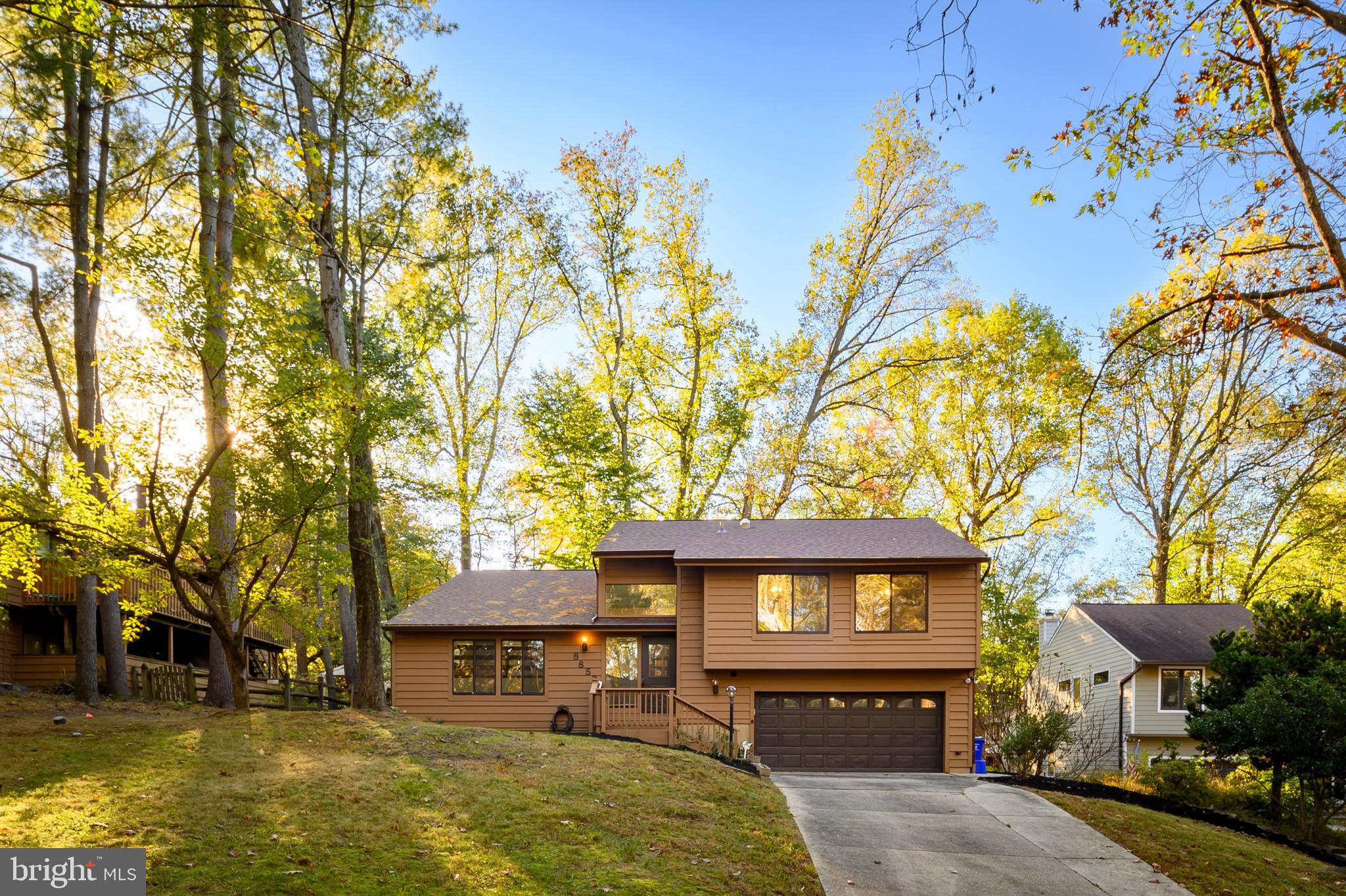 a front view of a house with a yard and a garage