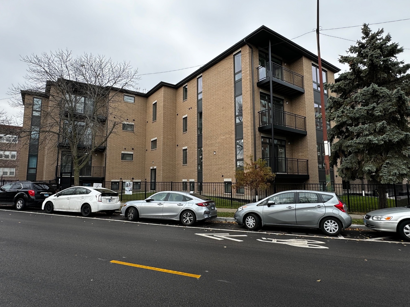 a couple of cars parked in front of a house