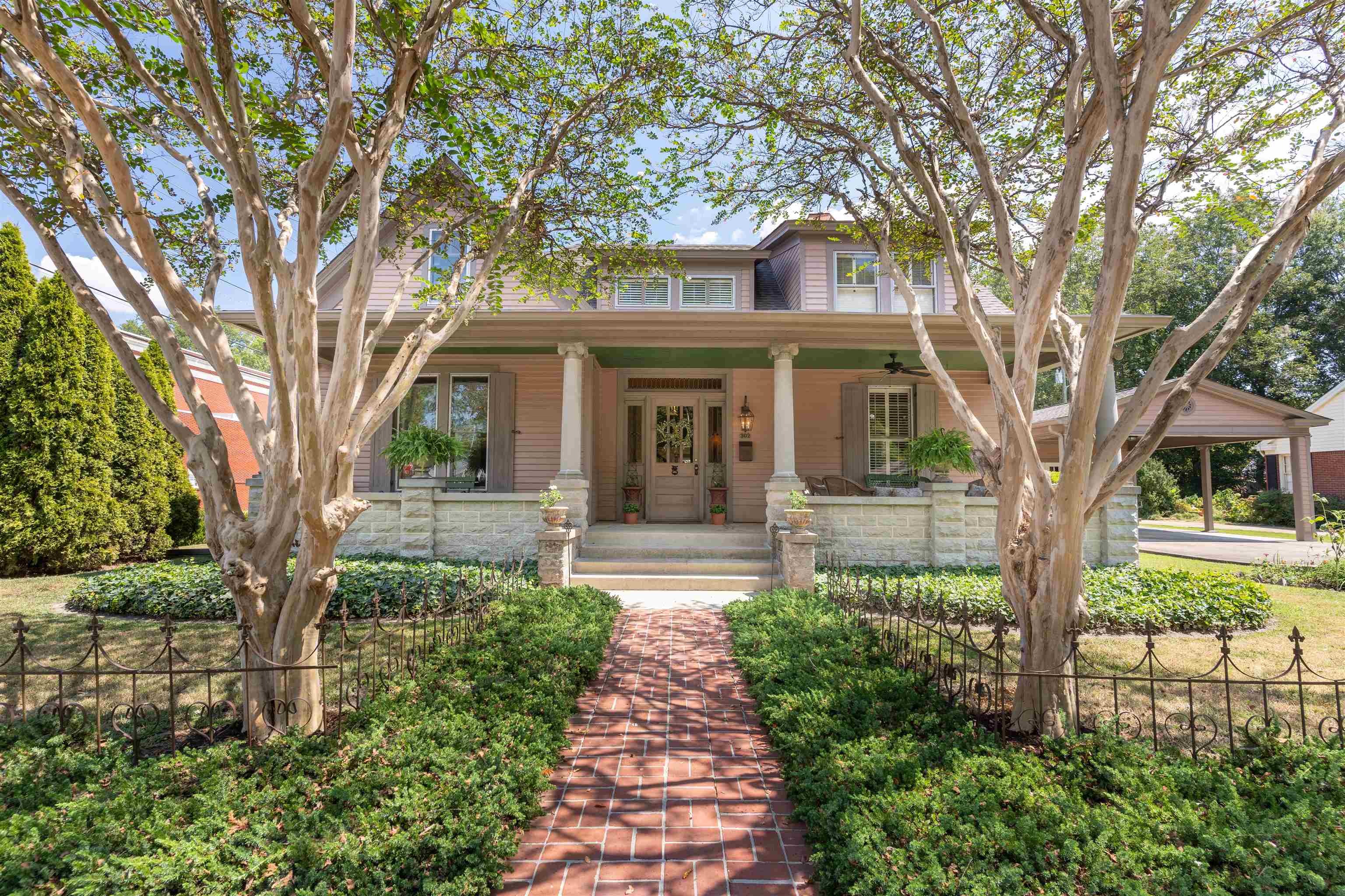 a front view of a house with a garden