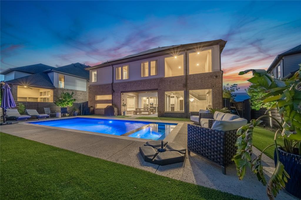 a swimming pool with outdoor seating and yard