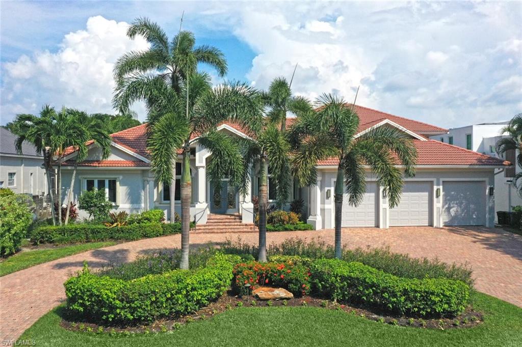 a view of a house with a yard and potted plants