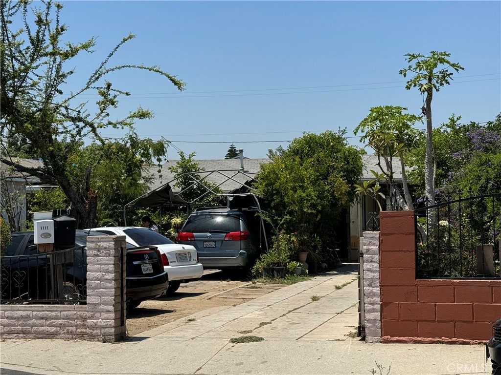 a view of street with bench and trees