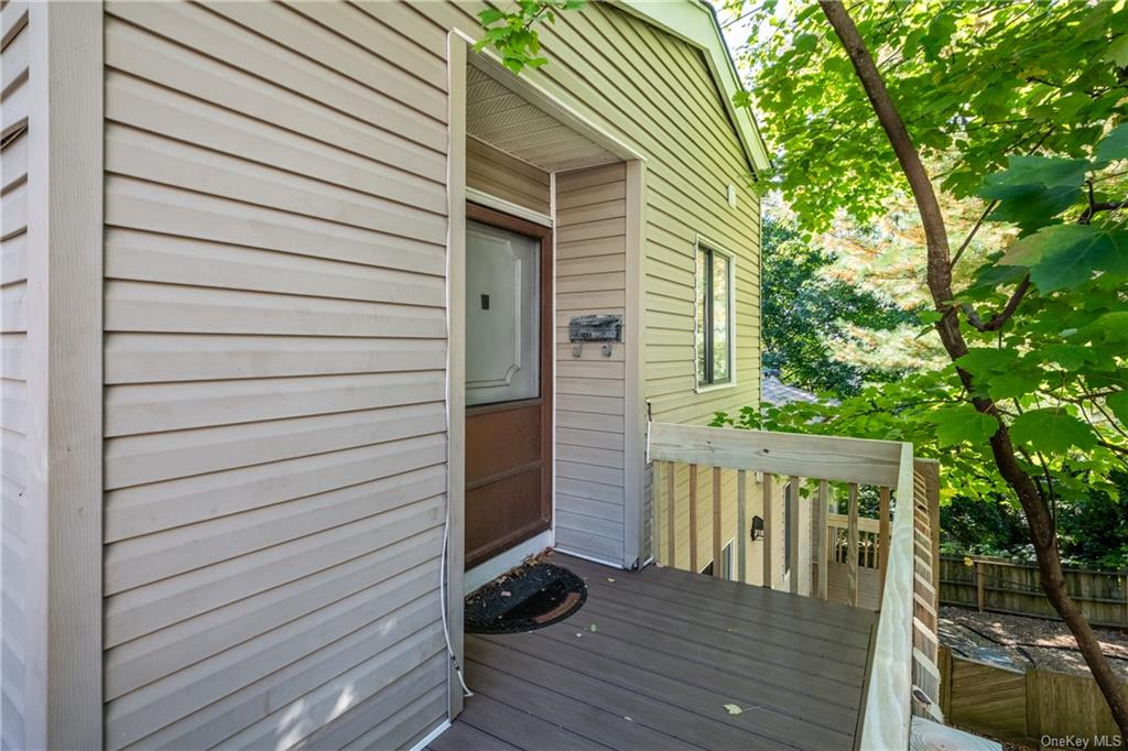 Doorway to property featuring a wooden deck