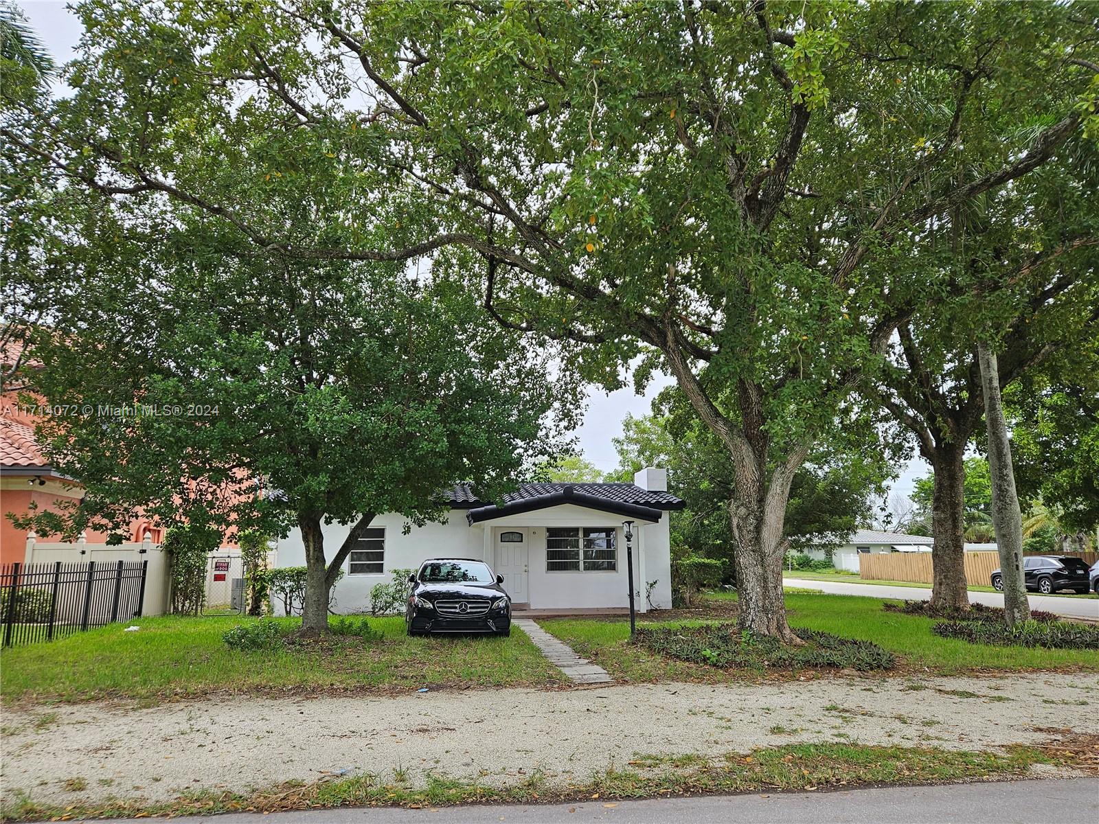 a house that has a tree in front of it