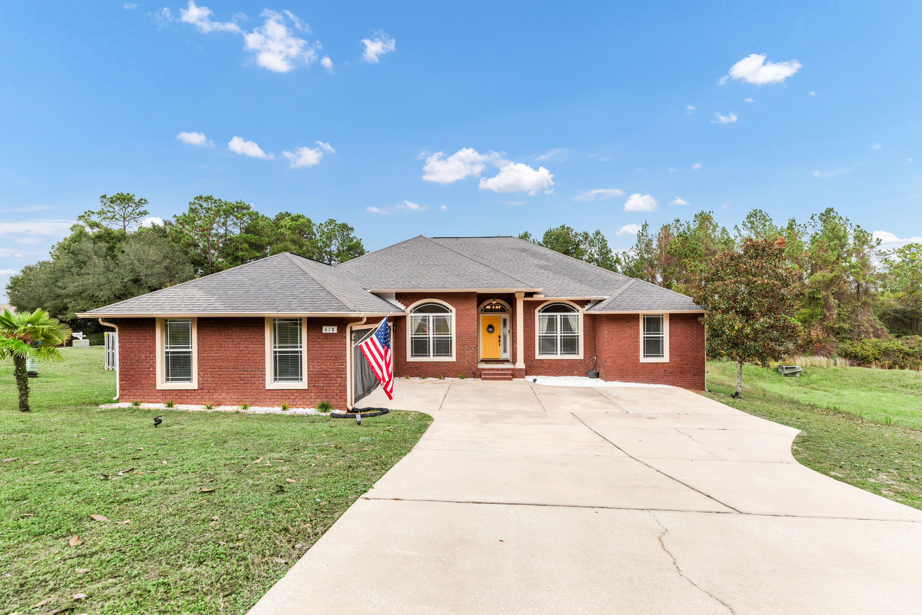 a front view of a house with yard