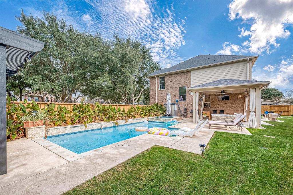 a view of a house with a yard and sitting area