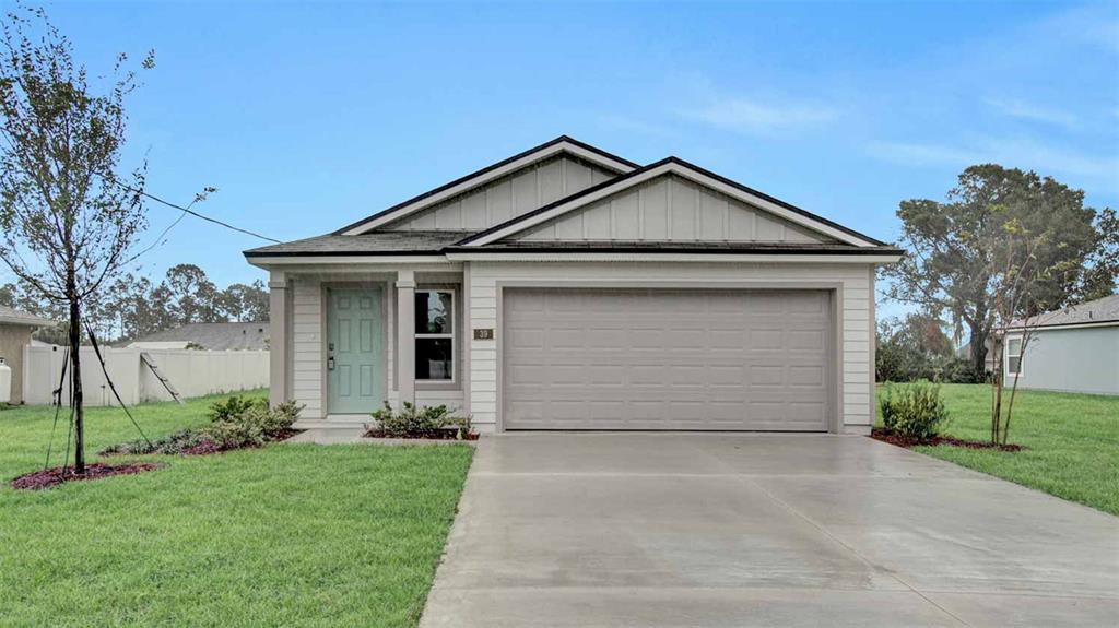 a front view of house with garage and yard