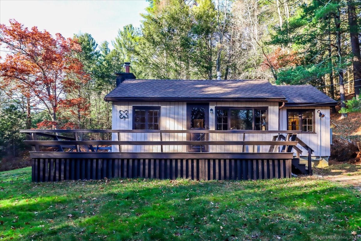 a view of a house with a yard and deck