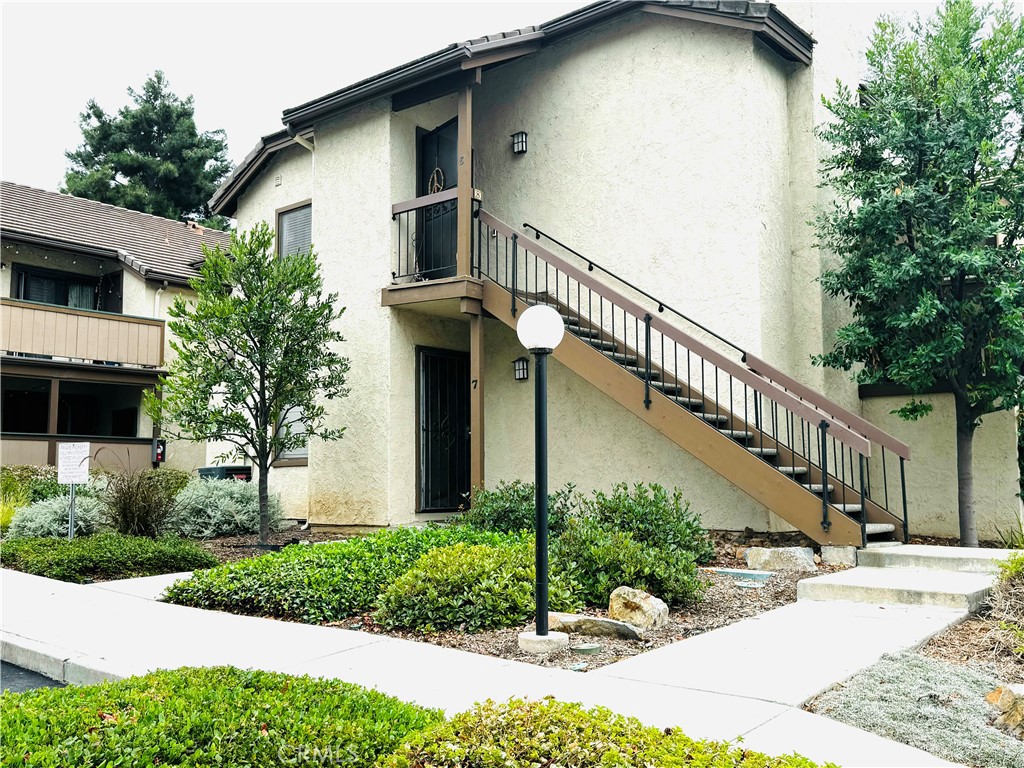 a front view of a house with a yard garage and outdoor seating