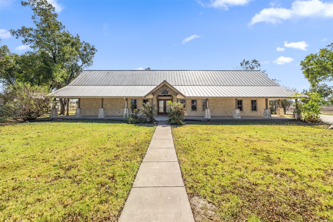 a front view of a house with a swimming pool