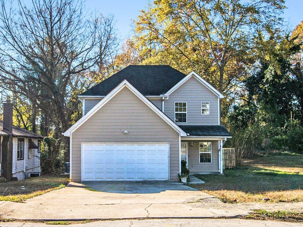 a front view of a house with a garden