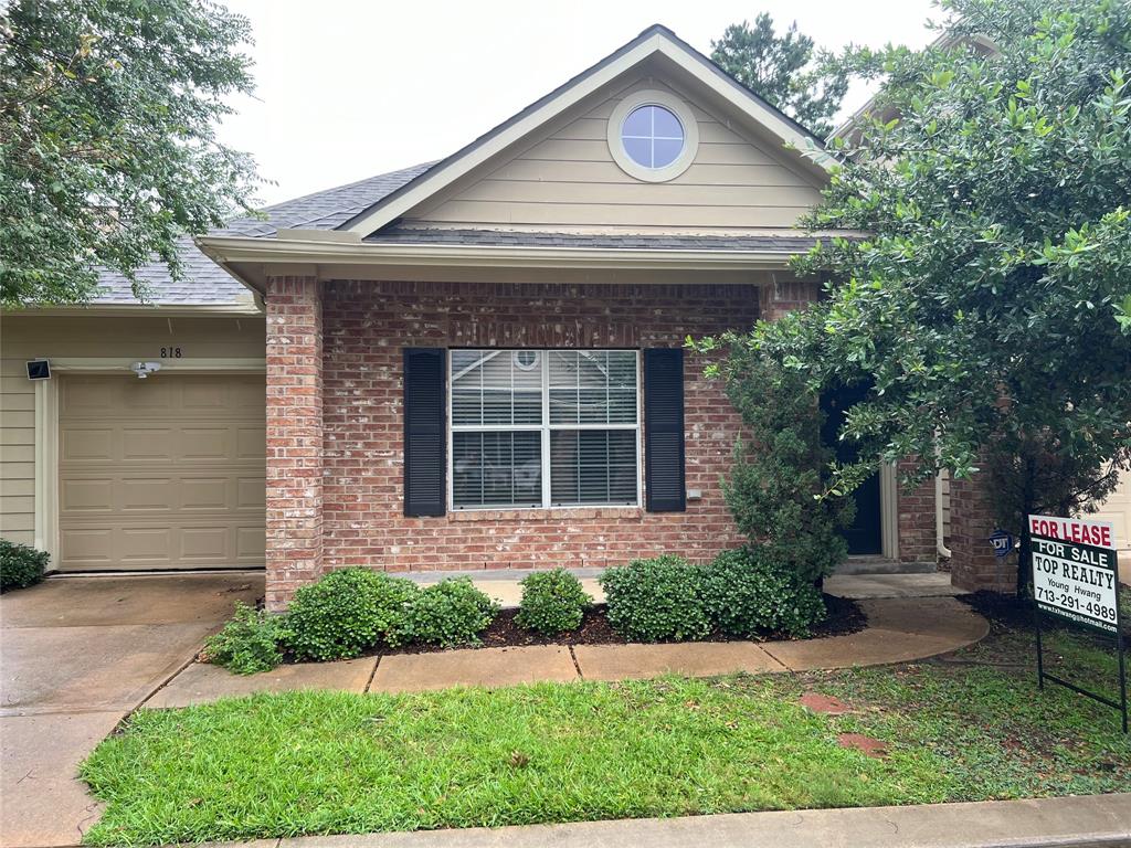 a front view of a house with a garden and plants