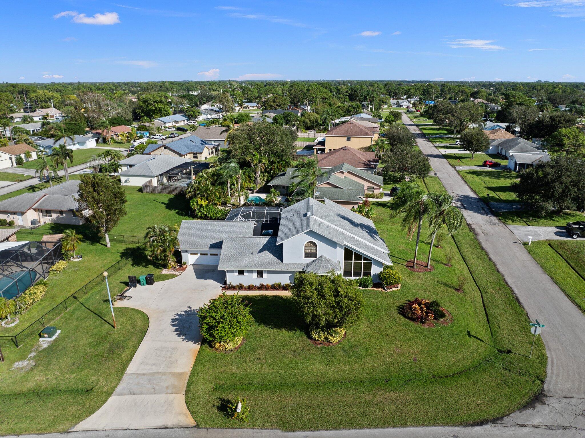 an aerial view of a house with a yard and lake view