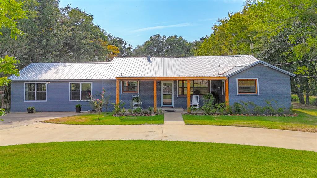 a front view of a house with a yard and porch