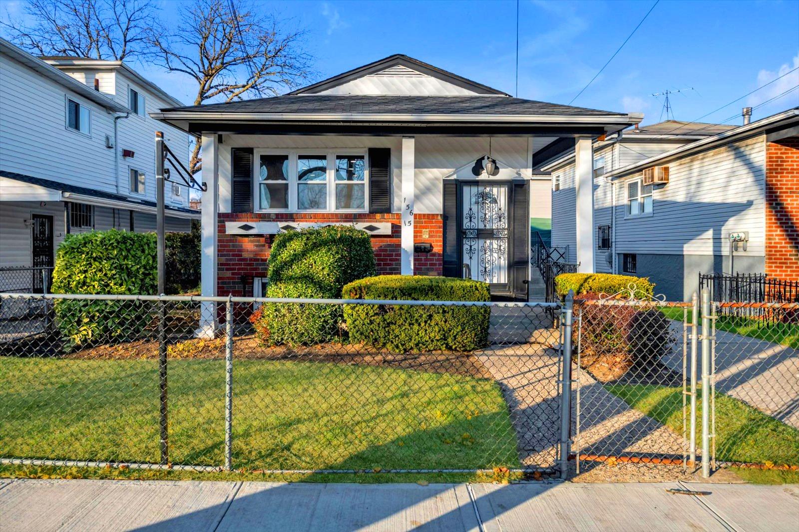 Bungalow-style house with covered porch and a front lawn