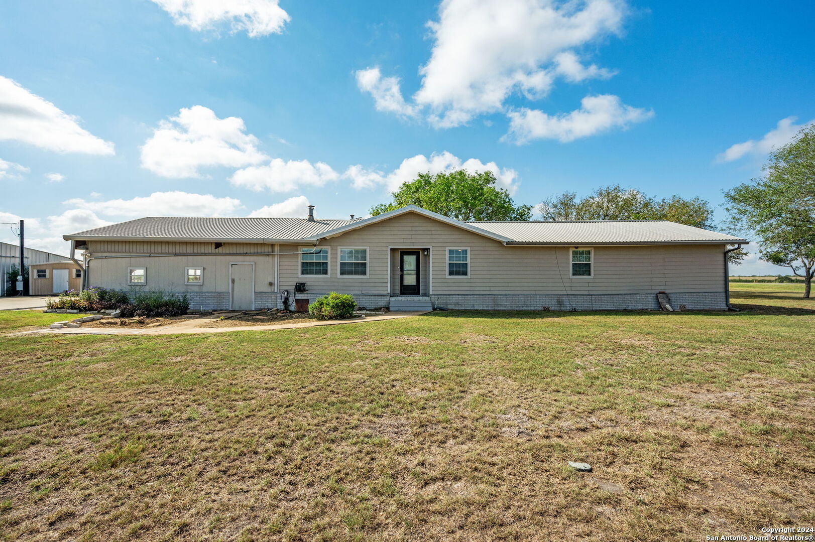 a front view of a house with a garden