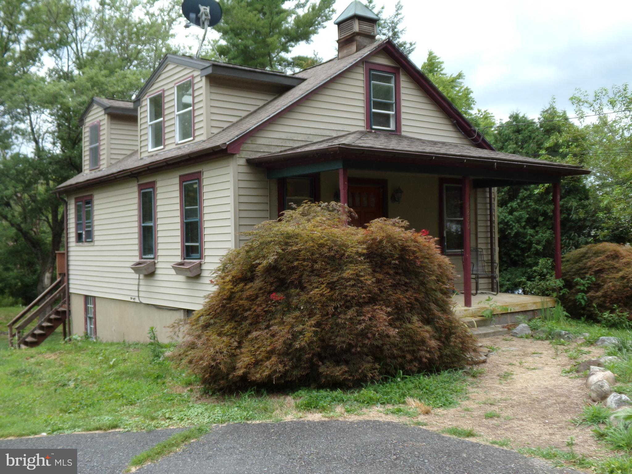 a front view of house with a garden