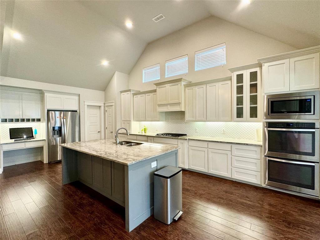 a kitchen with stainless steel appliances granite countertop a stove and a sink