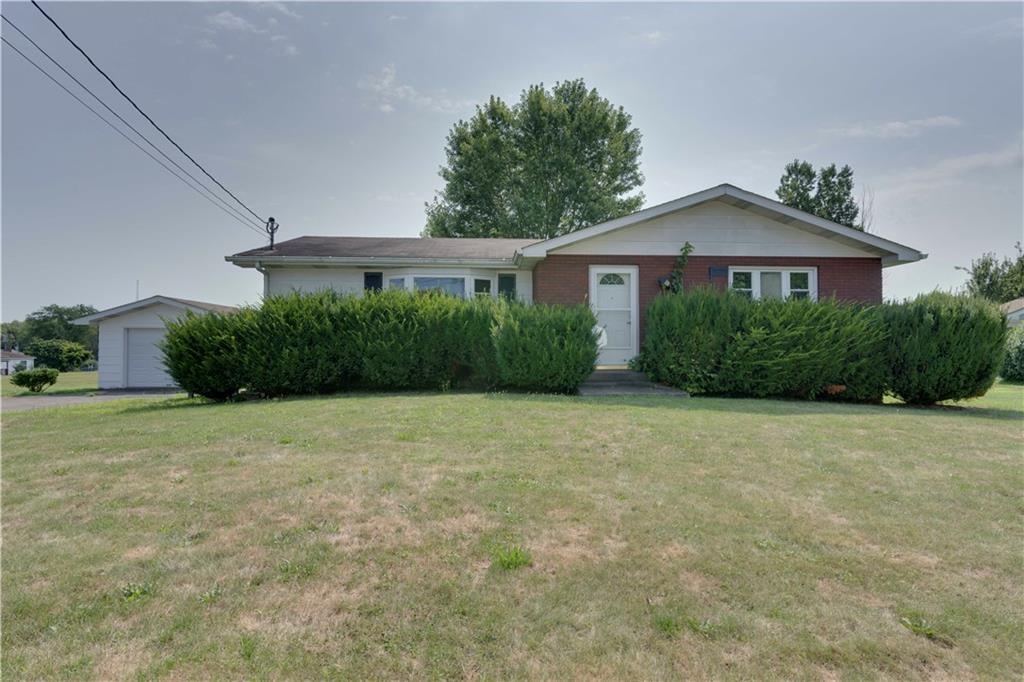 a front view of a house with yard and green space