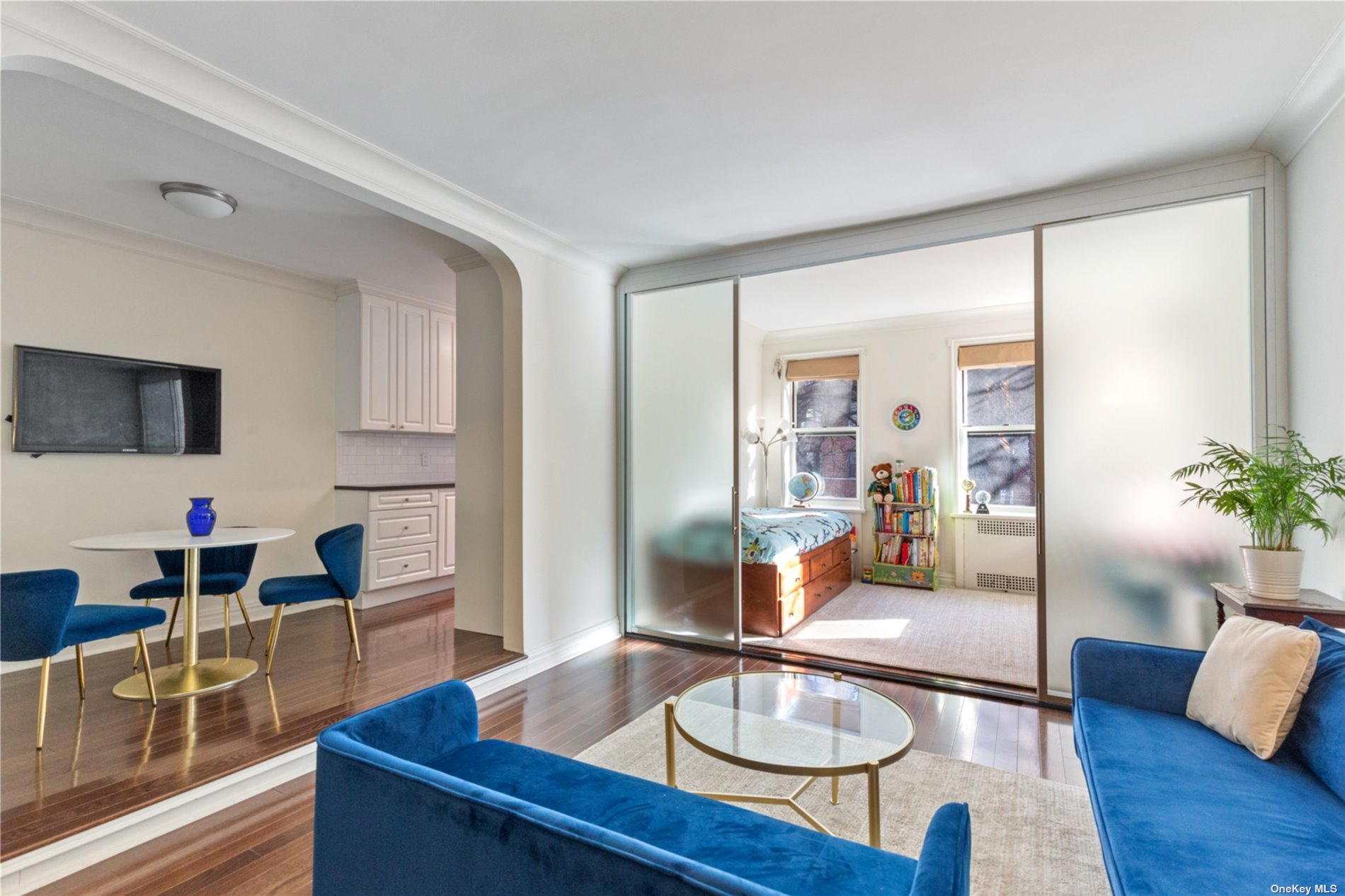 a living room with furniture and wooden floor