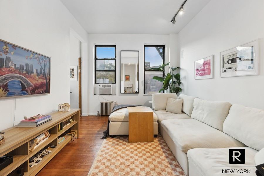 a living room with furniture and large window