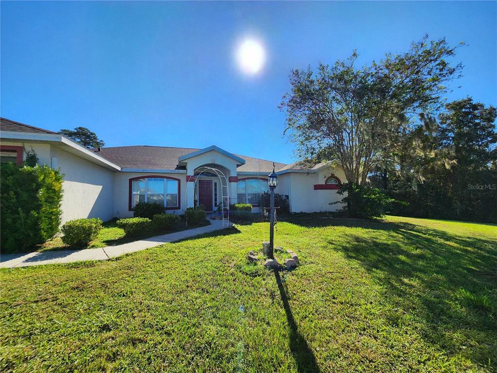 a front view of house with yard and green space