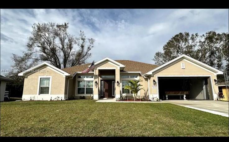 a front view of a house with a yard and garage