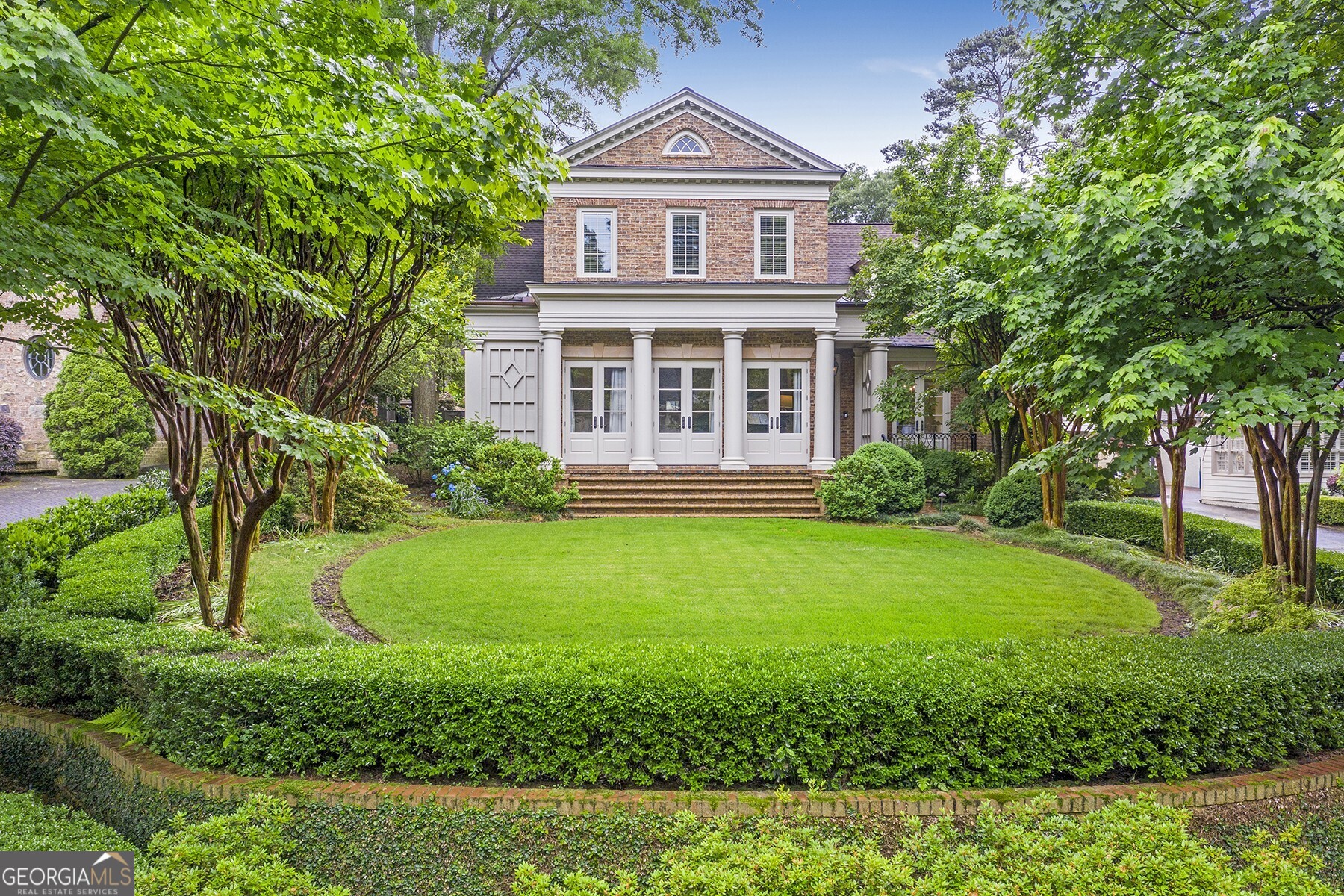 a front view of a house with garden